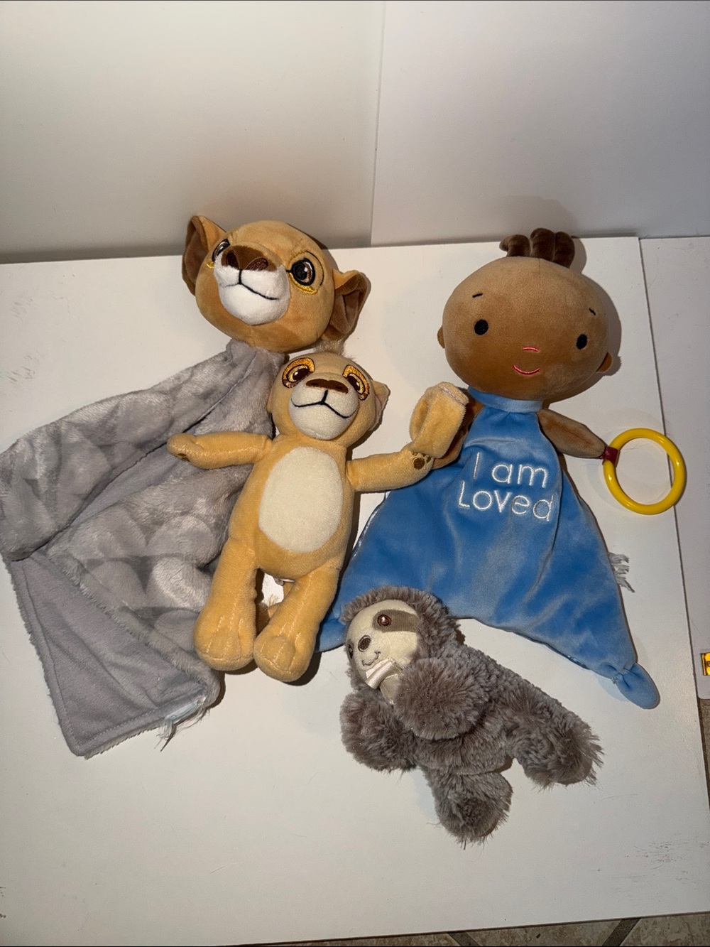 Blue 'I Am Loved' Plush Comfort Lovey with other stuffies and paci holder